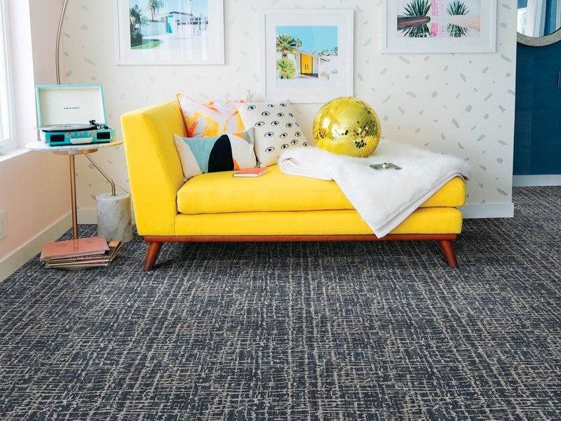 yellow couch on a gray carpet from Stoller Floors in Orrville, OH